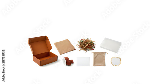 Eco-friendly packaging flat lay with brown cardboard box, kraft paper, twine, gift bag, tissue paper and tape on white background Thanksgiving