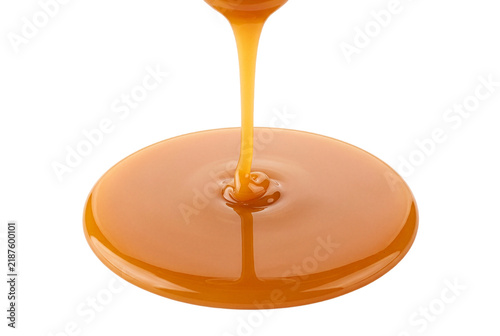 Obraz na płótnie Rich Golden Liquid Caramel Pouring into a Smooth Pool
