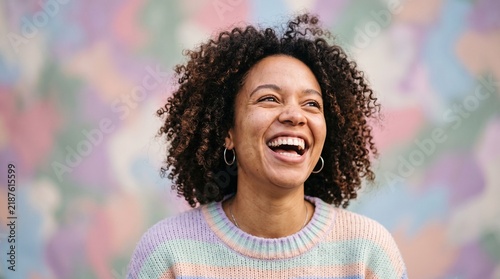 Happy Woman Laughing in a Colorful Pastel Setting
