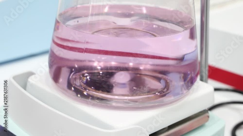 Lab shaker. Scientific orbital shaker mixing liquid solutions in Erlenmeyer flasks or test tubes. Medical chemical or biotechnology research pharmaceutical laboratory experiments and scientific tech.