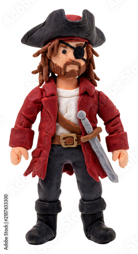 Handmade clay pirate figure with eye patch and sword on white background