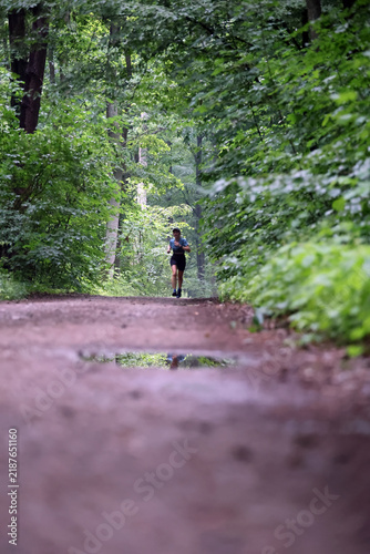 Athletic Woman Running on Forest Trail
