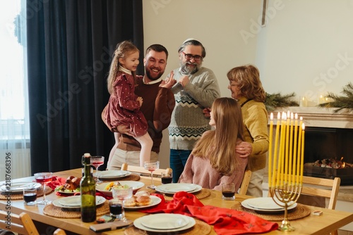 Quadro su tela Jewish family celebrating hanukkah dinner together at home