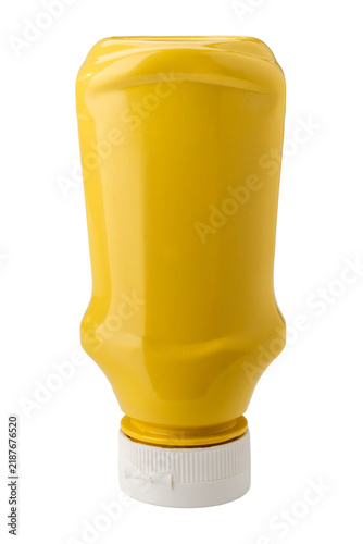 An upside-down yellow plastic squeeze bottle for mustard condiment, blank with no label and closed with a white plastic cap, isolated on white background with clipping path