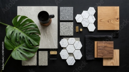 Top view template of a creative black architect moodboard with textile samples, building materials, and natural accessory elements.