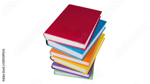 Bild auf Leinwand A neat vertical stack of colorful hardcover books with colorful hardcover educat
