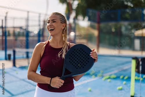 Фотография Happy sportswoman having fun while playing paddle tennis outdoors