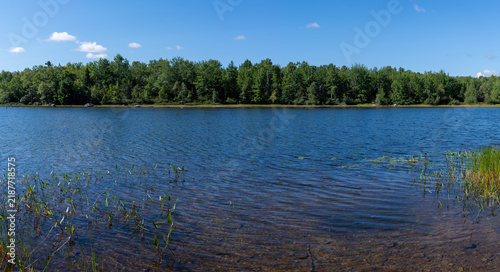 Wide view of Toddy Pond in Orland Maine on a warm summer day.