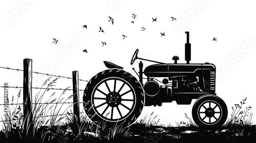 Black silhouette of vintage tractor parked in rural farm field with flying birds above grass