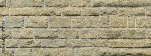 Фотография Light green yellow sandstone brick wall surface texture background with rectangu