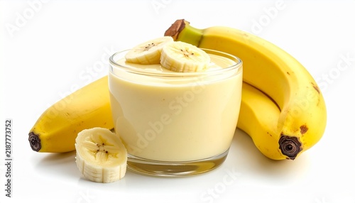 healthy yellow banana smoothie beverage in glass with fruit