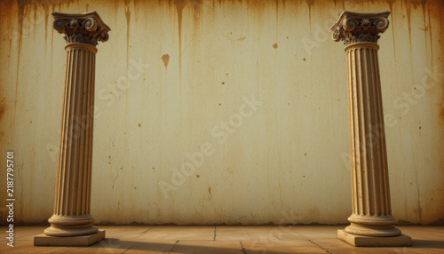 Two ancient classical columns stand on stone floor against weathered wall, evoking historic and timeless atmosphere