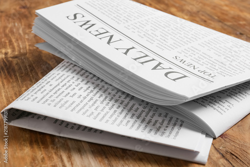 фотографія Journalism and media industry, daily newspaper with top news headlines on a wood