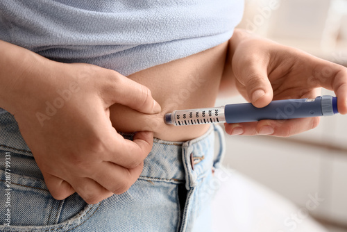 Bild auf Leinwand Diabetes management and insulin therapy, person injecting medication into abdome