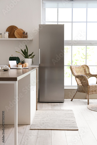 Stylish fridge in interior of kitchen