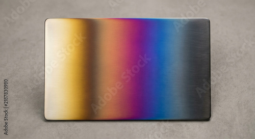 Polished stainless steel plate with heat oxidation color gradient rainbow temper spectrum macro studio shot