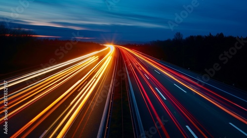 Highway at night with glowing speed light streaks.
