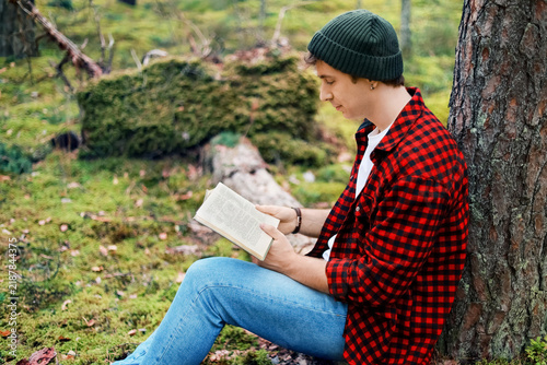 Fotografie peaceful man reading a book in an outdoor forest, enjoying relaxing leisure