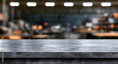 Empty metallic table top counter on blurred industrial factory background, ideal for product display montage, manufacturing showcase, and engineering concept.