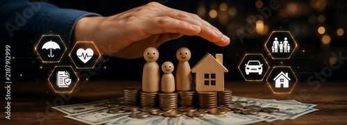 Hand protecting wooden family figurines on stacked coins with glowing insurance icons for financial and home security concept.