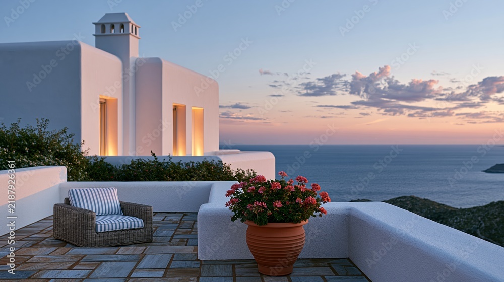 Fototapeta premium White terrace with wicker chair overlooking ocean sunset