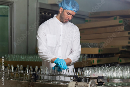 QC worker checking production line safety and hygienic standard in food and drink factory.