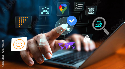 Person using a laptop and interacting with digital icons and holograms representing online research and reviews