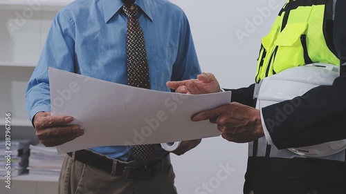 Close-up Of Person's engineer Hand Drawing Plan On Blue Print with architect equipment, Architects discussing at the table, team work and work flow construction concept