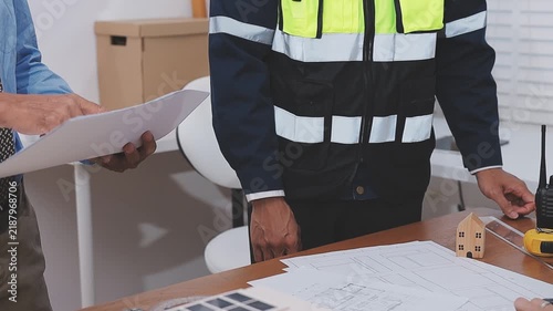 Close-up Of Person's engineer Hand Drawing Plan On Blue Print with architect equipment, Architects discussing at the table, team work and work flow construction concept