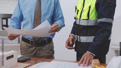 Close-up Of Person's engineer Hand Drawing Plan On Blue Print with architect equipment, Architects discussing at the table, team work and work flow construction concept