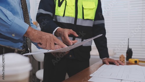 Close-up Of Person's engineer Hand Drawing Plan On Blue Print with architect equipment, Architects discussing at the table, team work and work flow construction concept