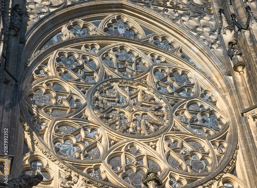 Close-up of the ornate Gothic rose window on the facade of St. Vitus Cathedral in Prague Castle, Czech Republic.