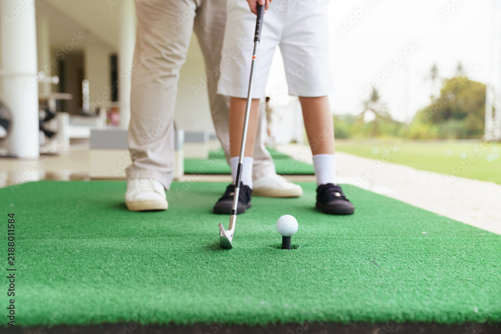 Obraz premium Professional golf coach guiding young student ball address position