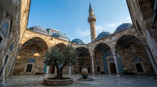 Courtyard of historical mosque with minaret and domes