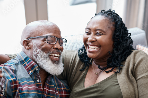 Canvastavla Relax, laugh and black couple in living room for bonding, love and weekend break in home
