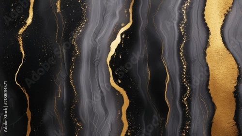 A luxurious abstract texture featuring a blend of deep black, dark gray, and streaks of metallic gold resembling liquid marble.