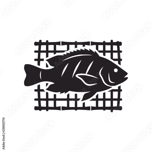 Black fish silhouette on bamboo grill