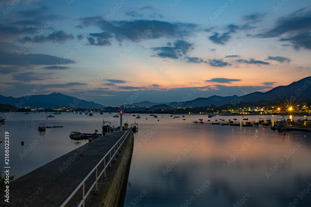 Fototapeta premium Beautiful sunset at Tai Mei Tuk in Summer. Tai Po, Hong Kong. Long Exposure