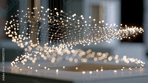 Modern hanging light installation with glowing spherical bulbs arranged in a flowing wave pattern indoors