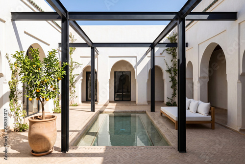 Modernist Steel Frame Courtyard with Shallow Reflecting Pool and Plaster Colonnade