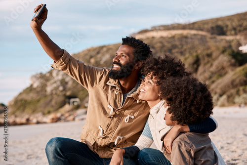 Beach, hug and black family with selfie for photography, outdoor vacation or bonding together. Mom, dad and child with smile or capture moment on ocean coast for holiday trip, picture or memory