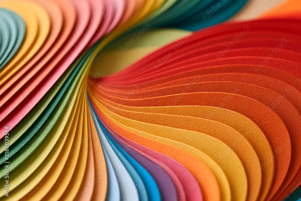 Naklejka premium Colorful paper layers swirl together in a vibrant design showcasing various hues and textures