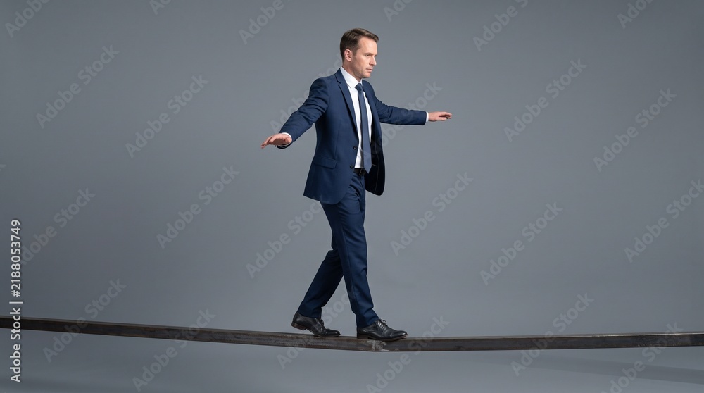 Fototapeta premium Professional businessman balancing on narrow beam demonstrating focus and precision in modern office setting