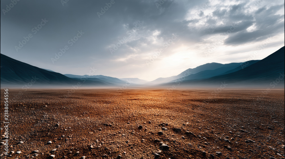 Obraz premium Vast empty desert landscape, dramatic sky, distant mountains, rocky ground, serene, sunrise light
