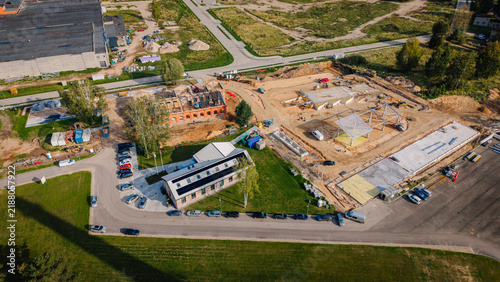 фотографія Aerial view of a construction site with multiple buildings under development, su