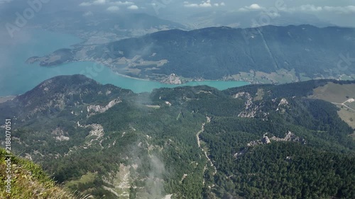 Misty landscape with mountain lake in nature. Mountain peak aerial view. Aerial misty landscape. Scenic nature over lake. Mountain peaks in mist. Aerial view of mountain landscape. Landscape panorama