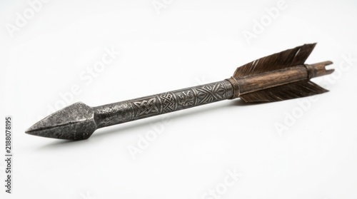 Ancient metallic arrow with decorative shaft and feathered fletching