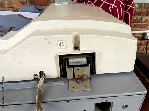 Photography Closeup of the hinge mechanism and wiring on the back of an old office photocopi