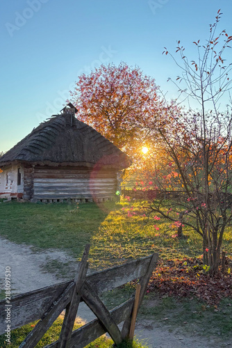 Golden autumn colors light up the countryside among old wooden houses and ancient churches in Ukraine, creating a warm nostalgic atmosphere.