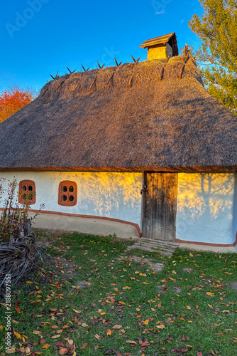 Golden autumn colors light up the countryside among old wooden houses and ancient churches in Ukraine, creating a warm nostalgic atmosphere.